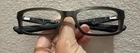 Oakley Eyeglasses Frames Only, Bucket, OX1060-0153, 53-17-140, Polished Steel Pre-owned. Price: $25.00.