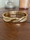 Vintage Monet Gold Tone Textured Spring Hinge Bangle Bracelet B564 Unspecified. Price: $14.00.